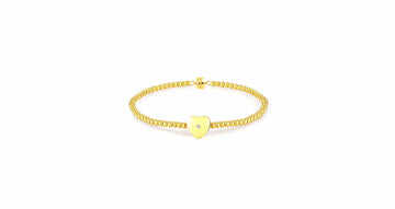 yellow gold plated bracelet featuring a natural diamond within a single heart-shaped accent charm.