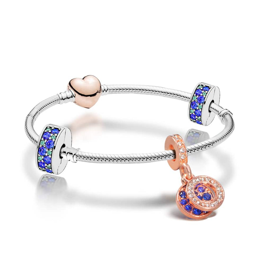 Blue and Rose Gold Plated charm Bracelet on a silver bracelet band with blue crystal charm and stoppers.