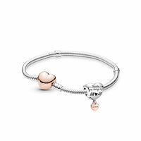 simply sentimental silver toned bracelet featuring a heart shaped dangling charm reading thanks for being my mum in a silver and rose gold colour, finished with a heart shaped rose gold clasp.