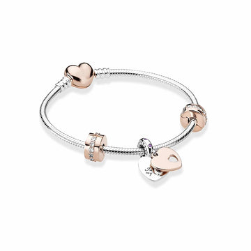 silver bracelet featuring rose gold charms, crystal stoppers and a love heart clasp fastening
