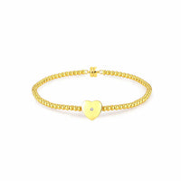 yellow gold plated bracelet featuring a natural diamond within a single heart-shaped accent charm.